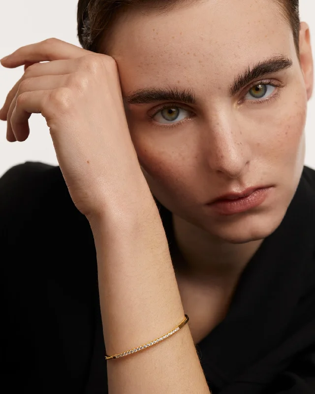 Minimalist bangle bracelets with a thin profile for a sleek and subtle appearance-GRID April Gold Bangle