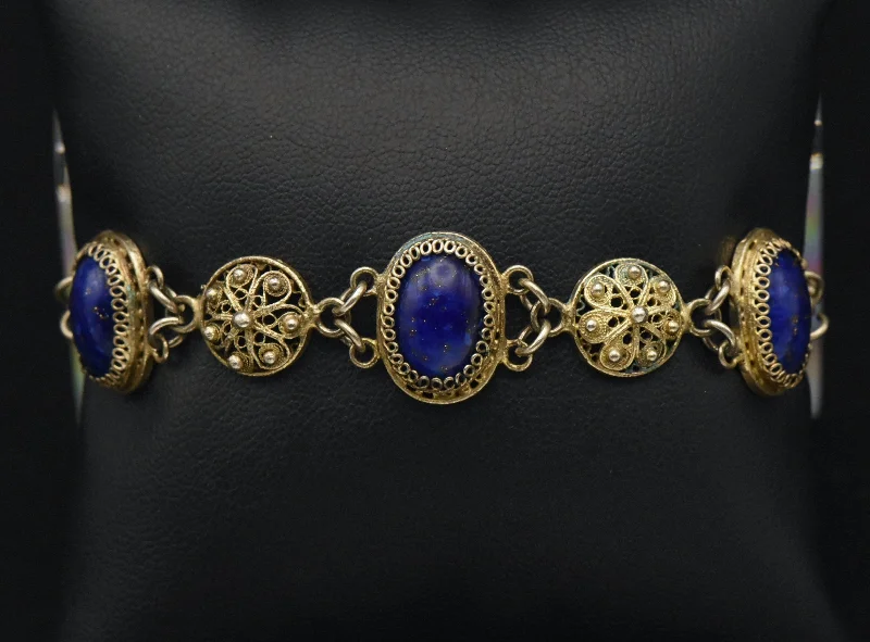 Simple gold bangle bracelets with smooth finishes for a classic and elegant style-Vintage Gold Tone Filigree and Imitation Lapis Lazuli Bracelet - 7"